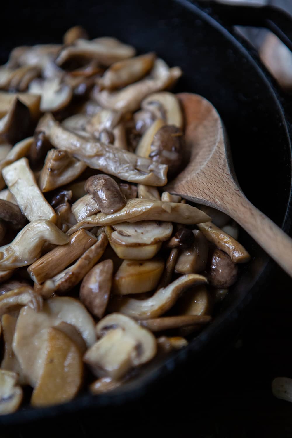 Cooking down mushrooms in a pan