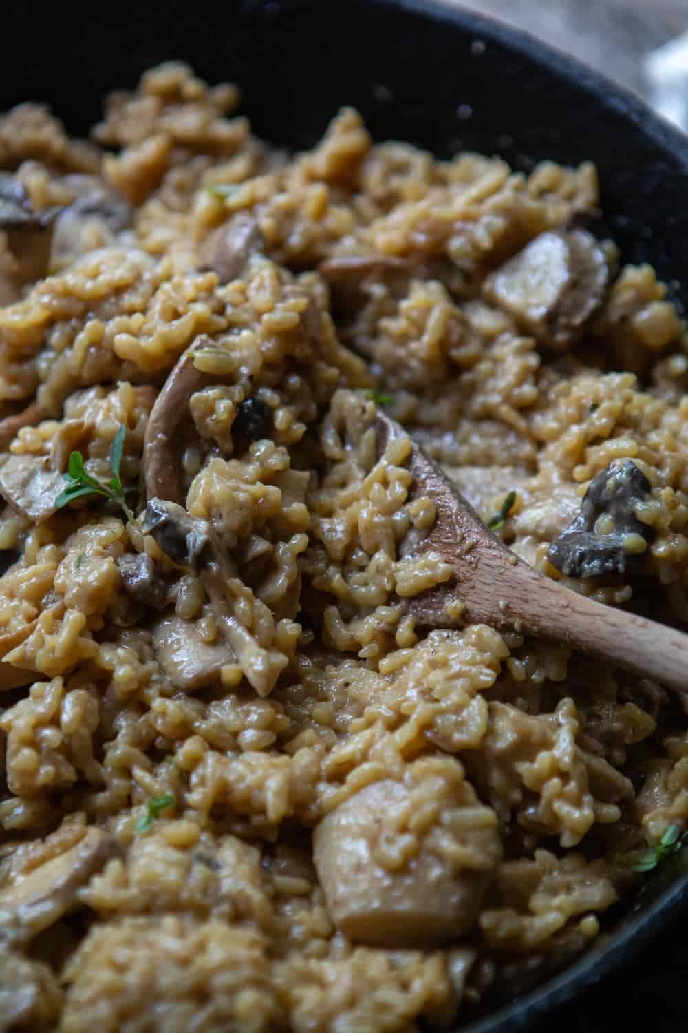 Mushroom risotto being cooked in a pan