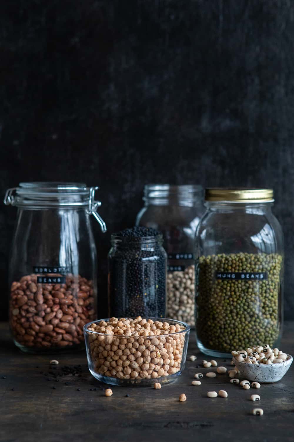 Jars filled with different legumes.