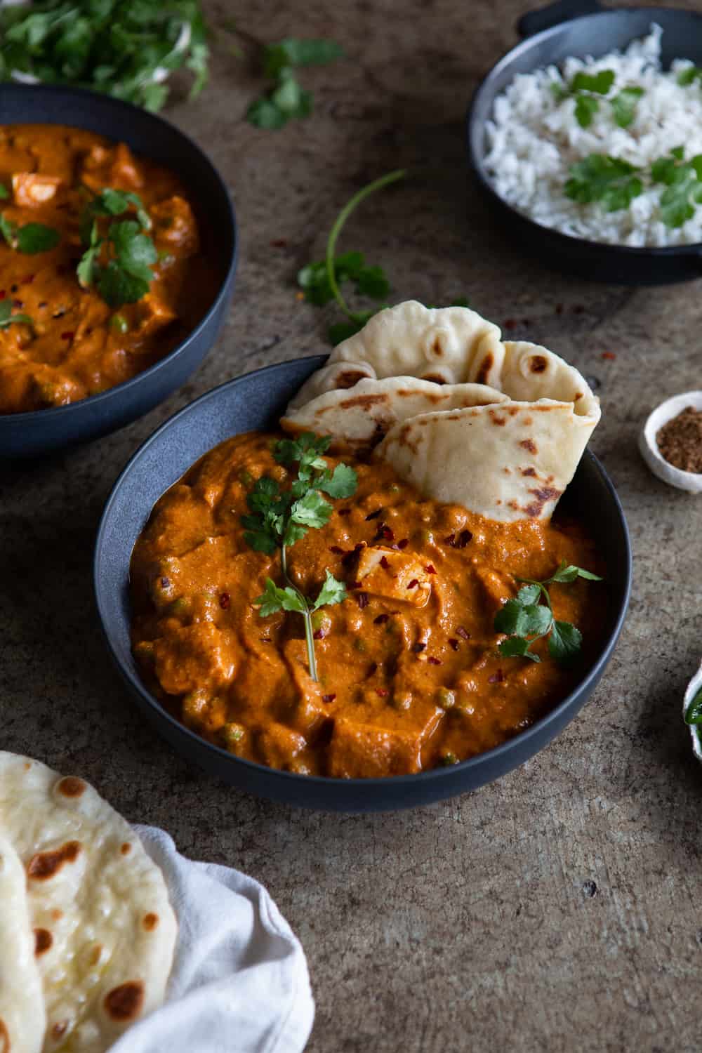 Tofu matar paneer served in bowl with naan bread