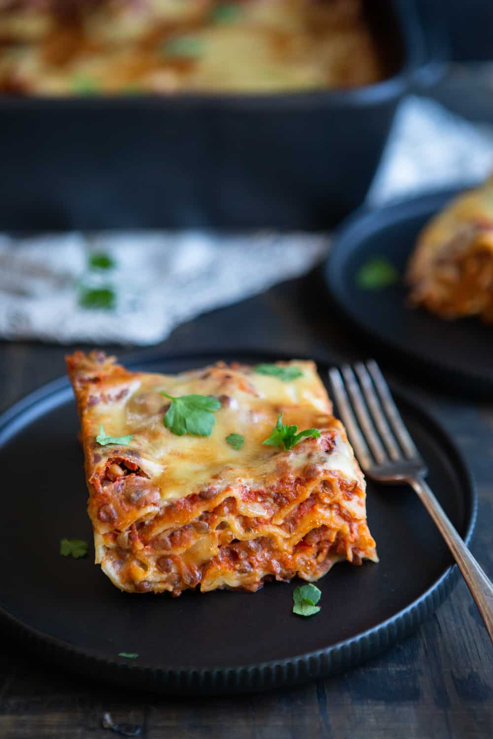 Slice of lasagna on plate.