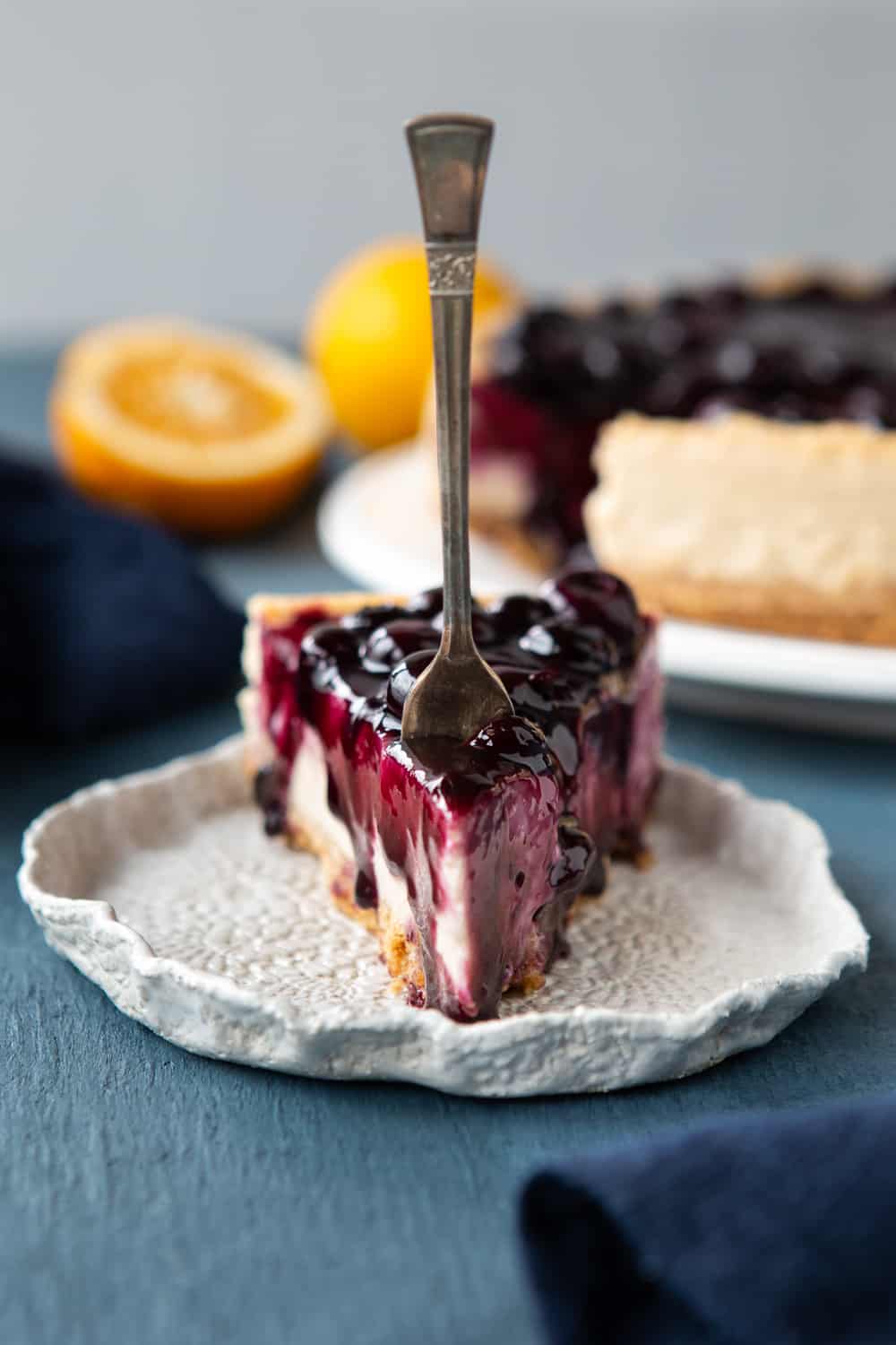 Baked Vegan Blueberry Cheesecake slice with a work in it