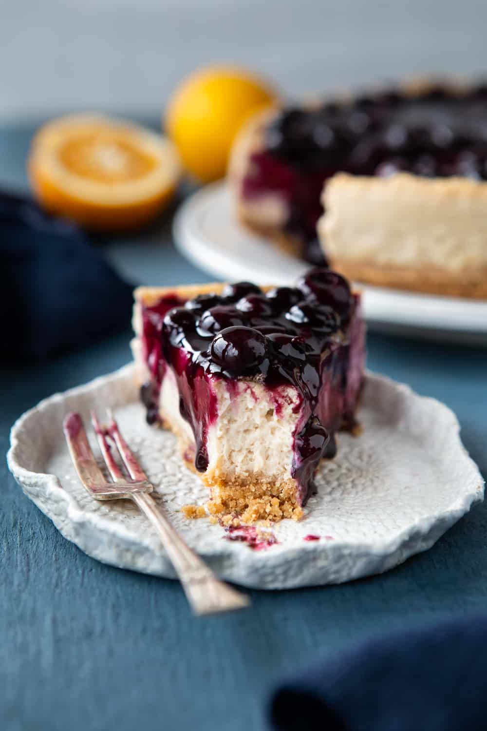 Baked Vegan Blueberry Cheesecake slice with an eaten piece