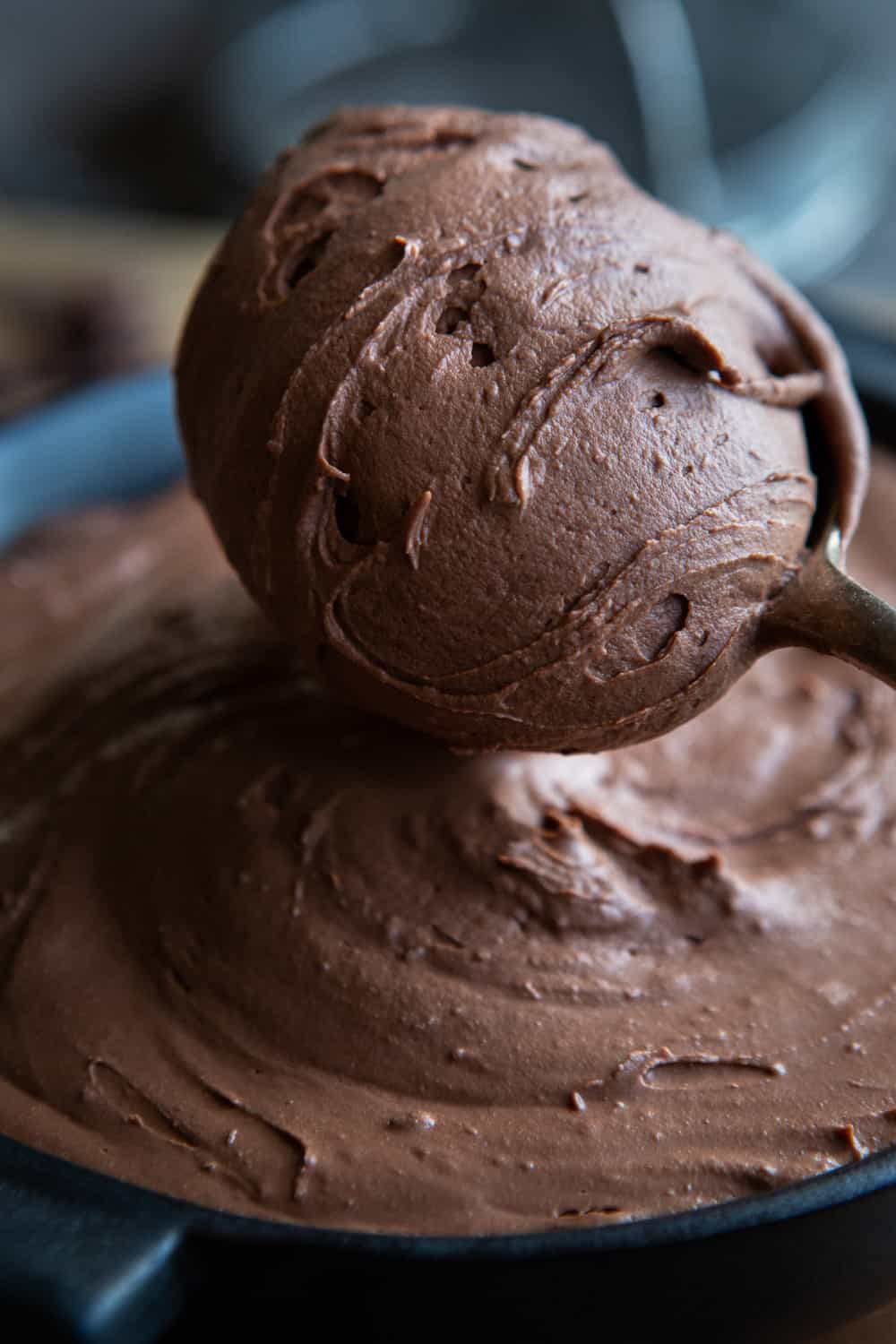 Vegan chocolate ganache being scooped up with spoon
