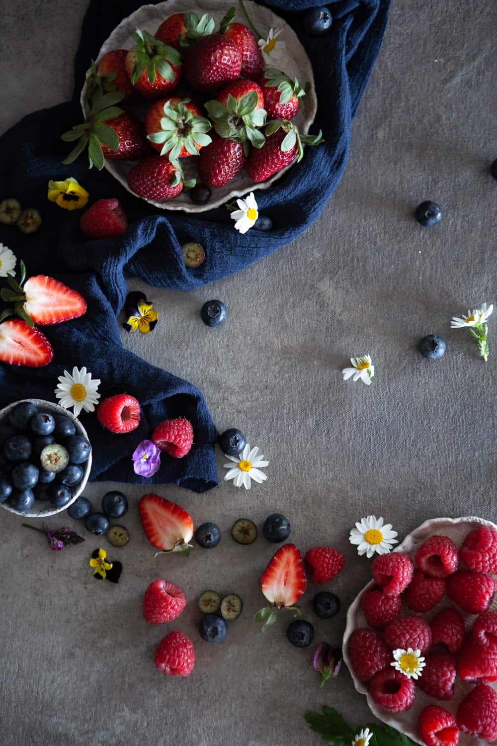 Berries and edible flowers shot from above