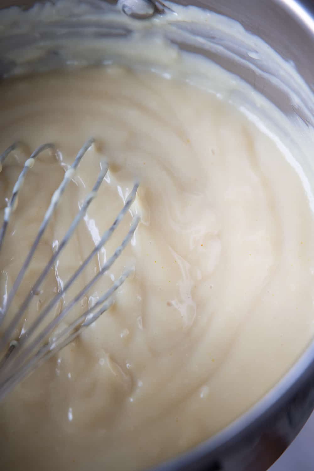 Thick Vegan Custard in pot with whisk.