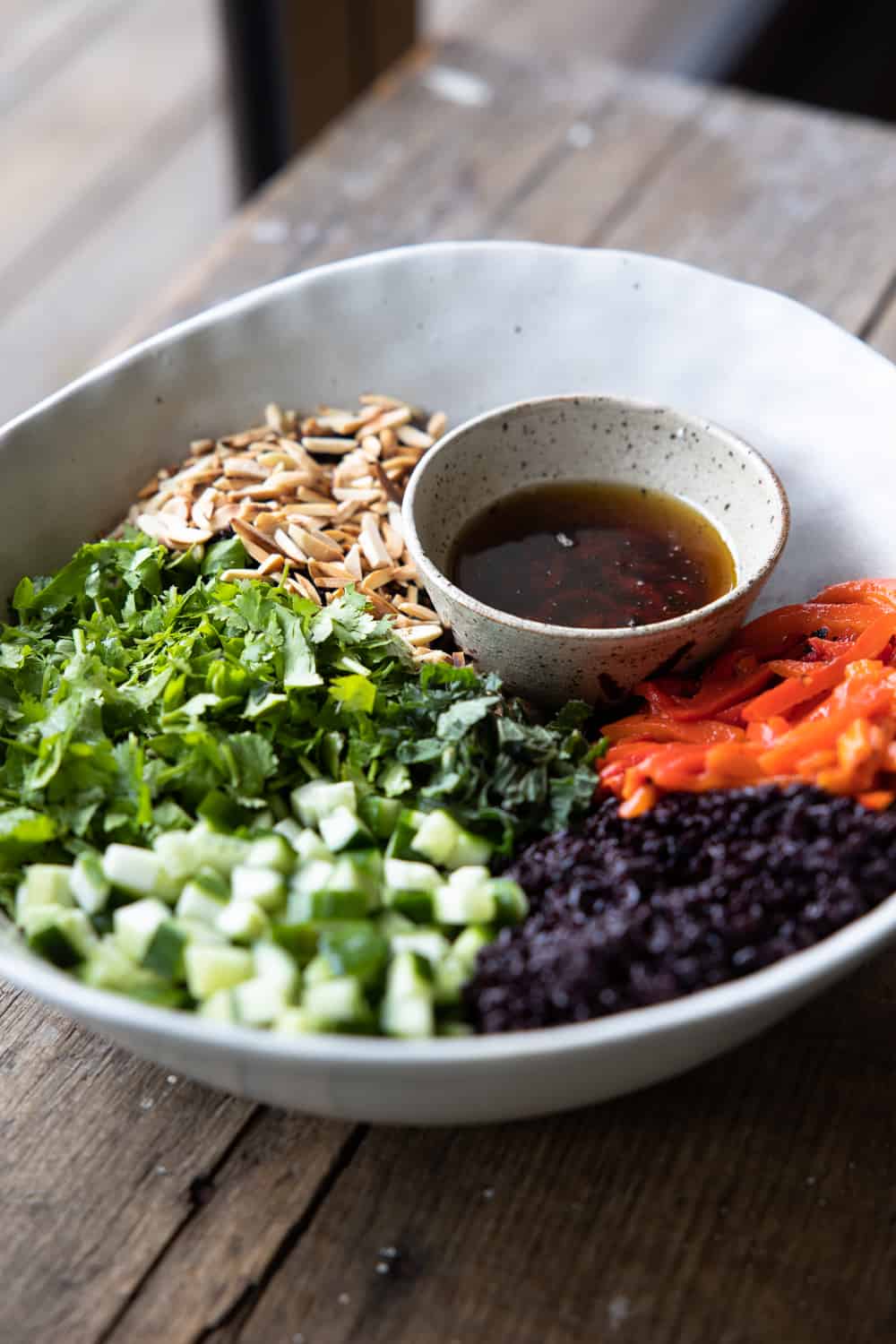 Black rice salad ingredients all in a large bowl.