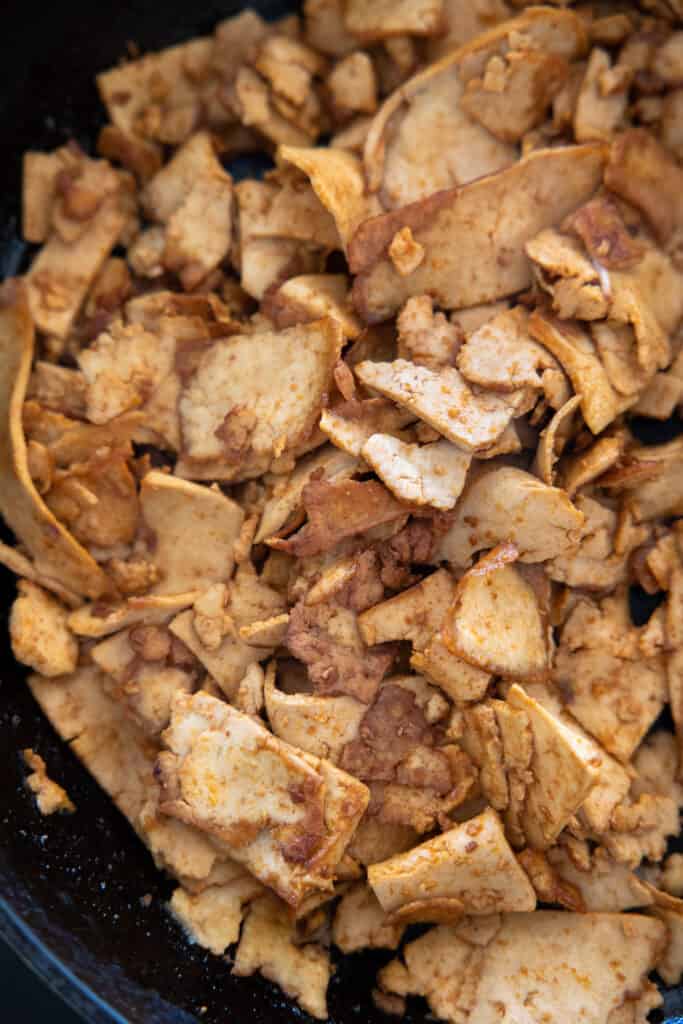Close up of crispy tofu inside a frying pan. 