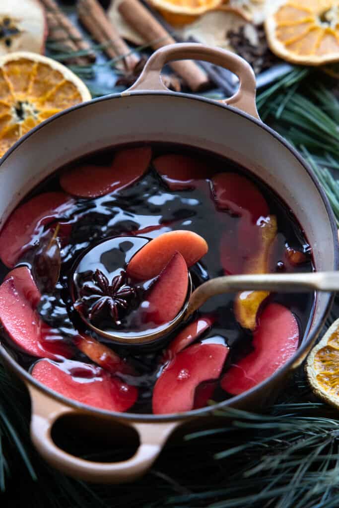 The mulled wine in pot ready to serve using a ladle to scoop out.