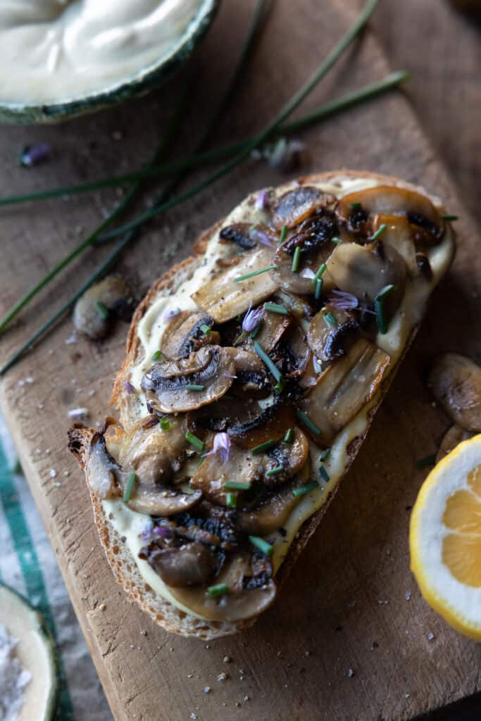 Cashew cream on bread with sauteed mushrooms and chives.