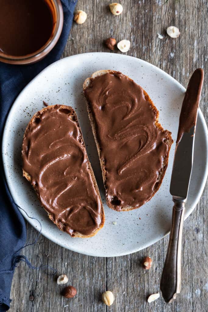 Chocolate hazelnut spread on two pieces of toast.