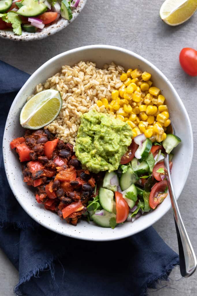 Healthy vegan burrito bowl shot from above in a bowl with a fork.