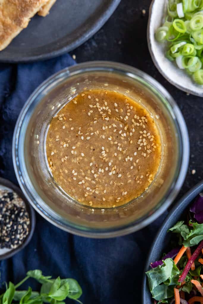 Sesame Miso Dressing shot overhead and close up in a jar.