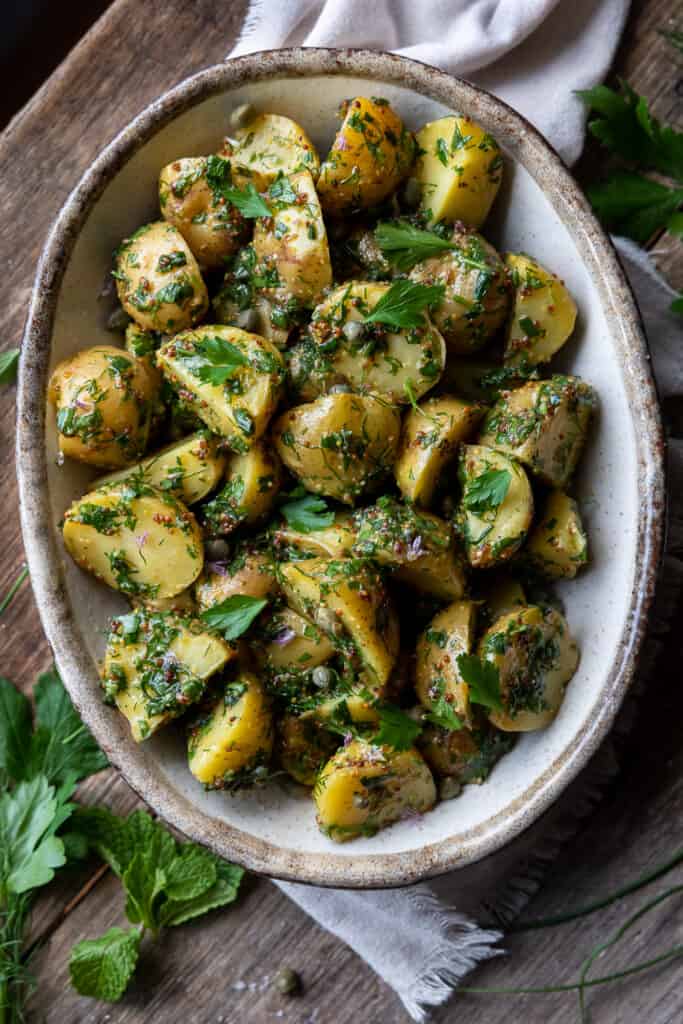 Potatoes covered in herbs, mustard and capers.