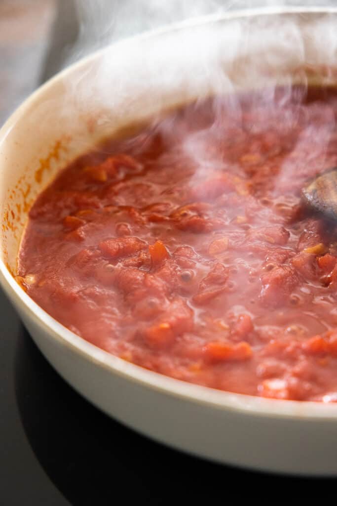 Tomato sauce simmering in pan.