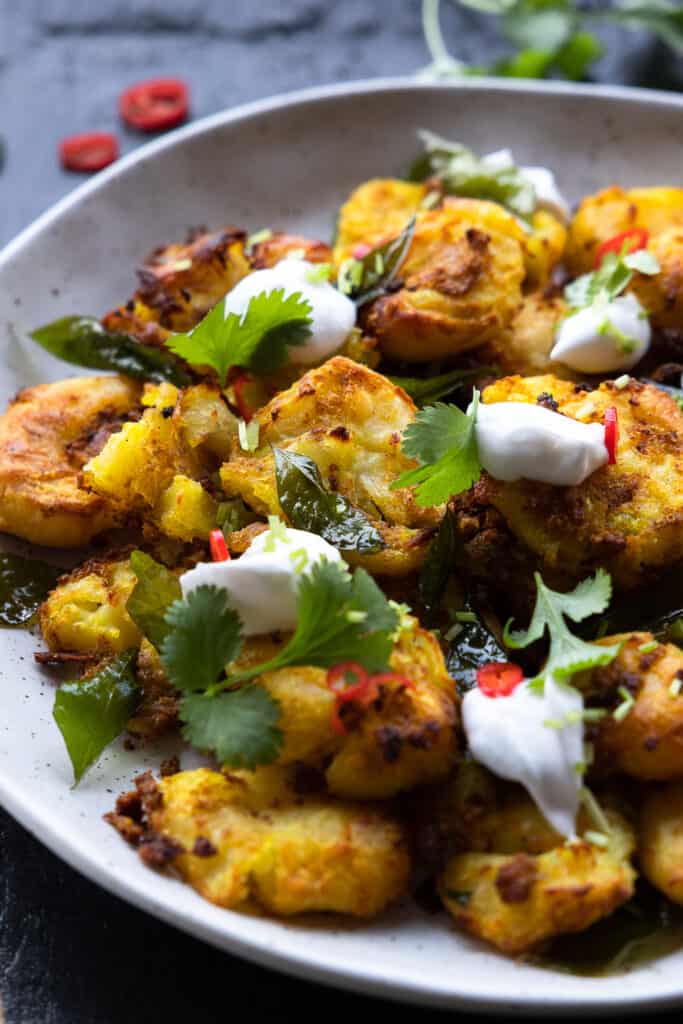 Close up of the Smashed Curry Roasted Potatoes on a plate.