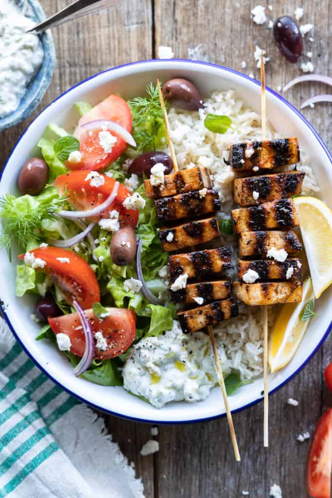 Vegan souvlaki made of tofu served with rice and Greek style salad.